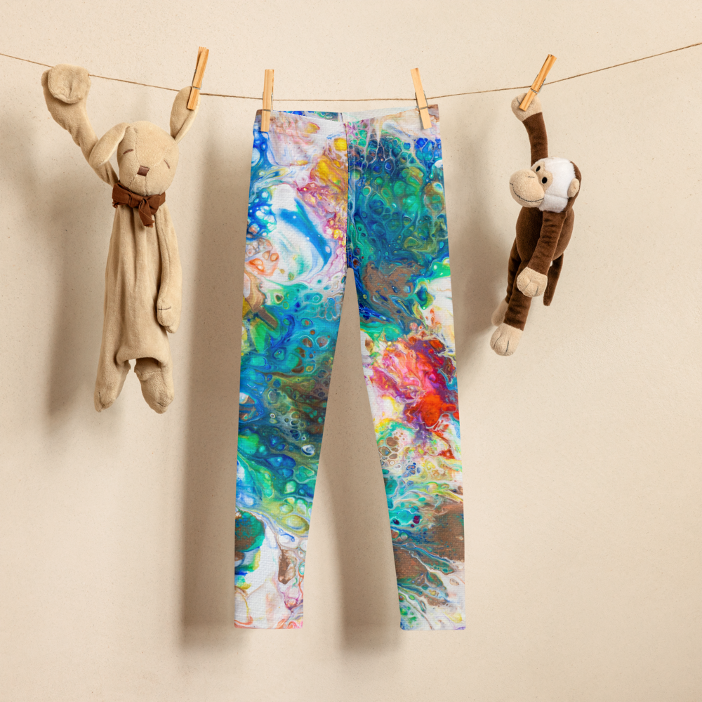 colorful girls yoga pants hanging on a clothesline in between two small stuffed animal toys